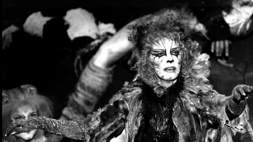 Black and white image of a woman in extravagant cat-like makeup
