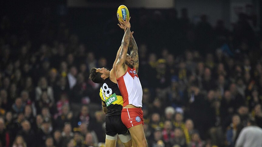 Alex Rance and Lance Franklin contest for the ball.