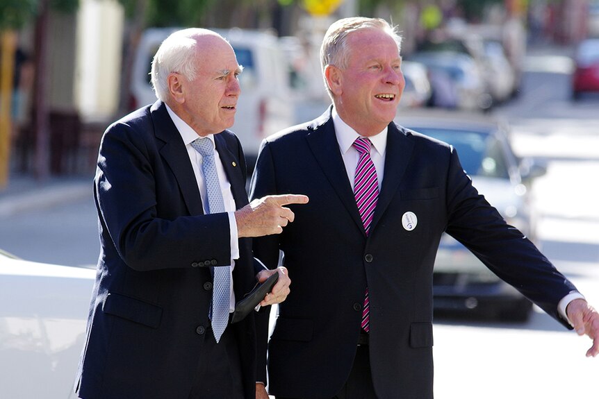 Premier Colin Barnett with former PM John Howard on a busy Perth street.