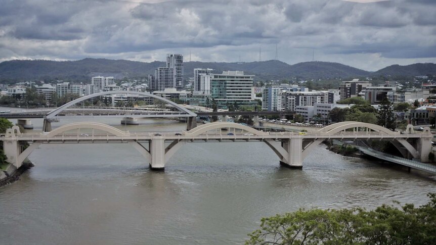 View of two bridges across a river beside a city