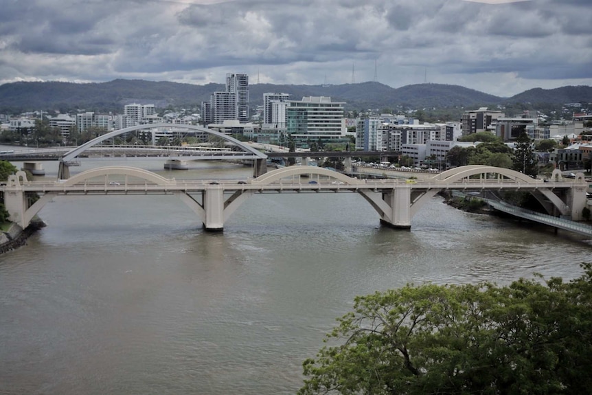 View of two bridges across a river beside a city