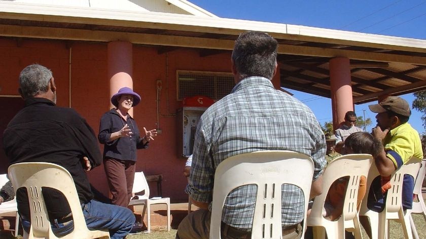 Cash incentive: A Government team at the Wallace Rockhole community west of Alice Springs