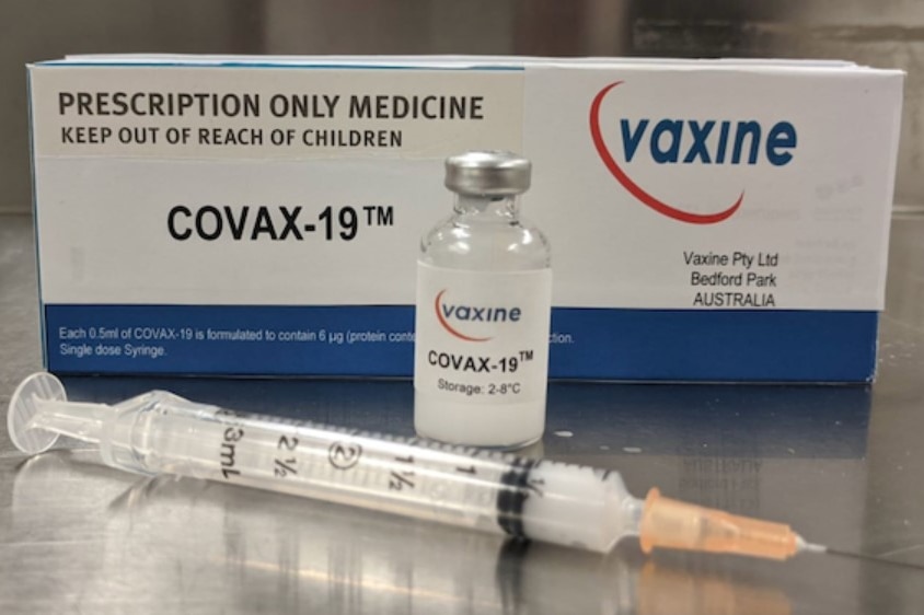 A syringe in front of a box of a trial coronavirus vaccine.