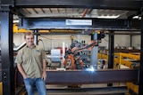 An image of Chris Brugeaud, CEO Smart Steel Solutions, in front of his robotic welder in Brisbane.