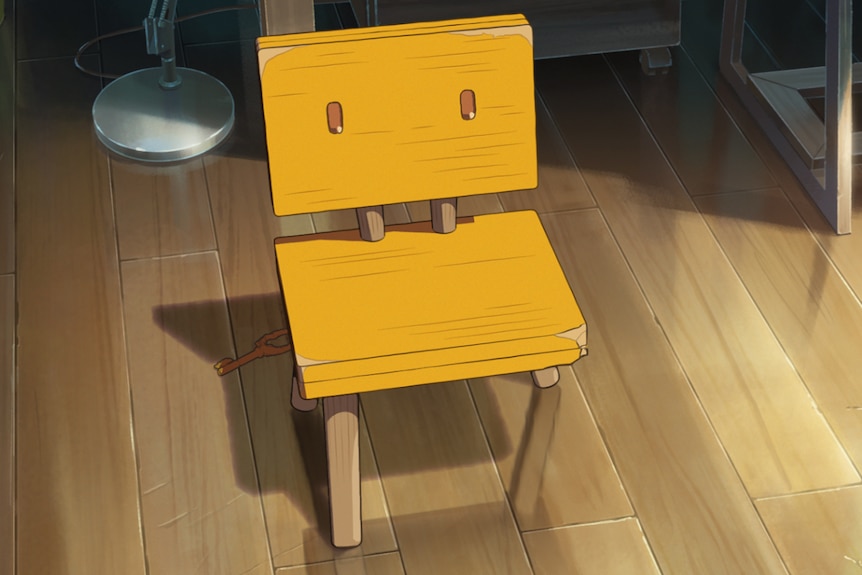 A still from an anime movie, featuring a yellow, three-legged chair, with its paint peeling, resting on floorboards.