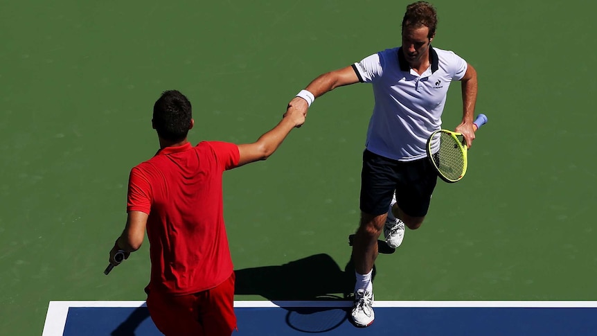 Richard Gasquet of France is congratulated by Bernard Tomic