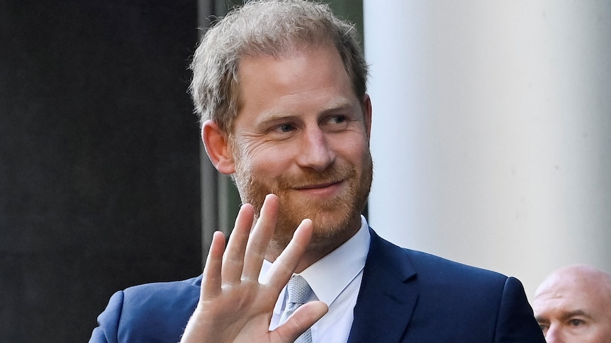 Prince harry smiles and waves 