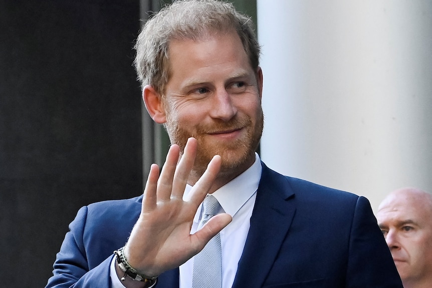 Prince harry smiles and waves 