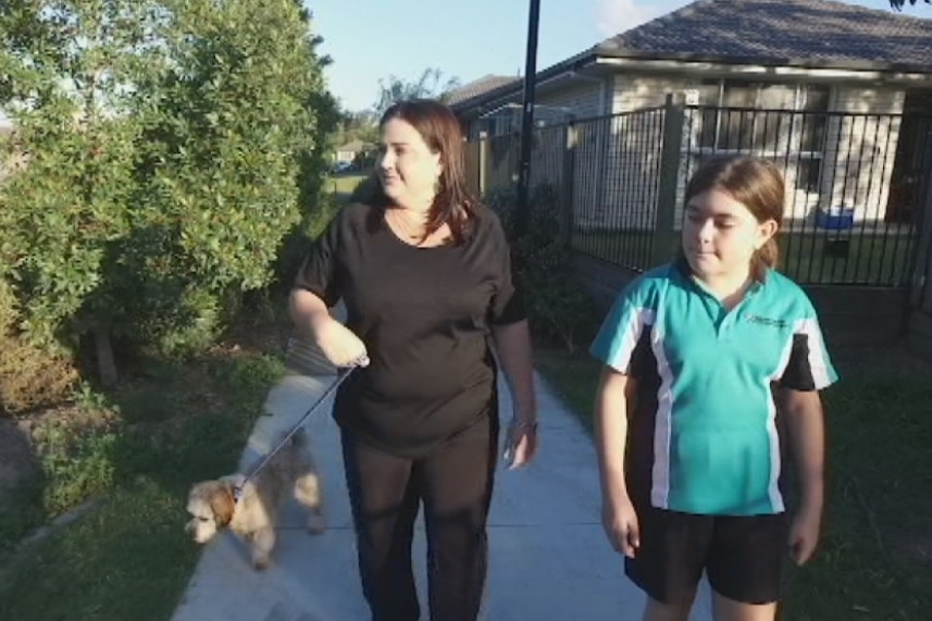 Angela and Rachel Hope walk their dog Gizzy.