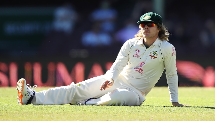 Australian cricketer Will Pucovski sitting on the pitch