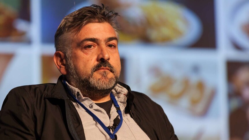 Restaurant owner Frank Camorra on stage at a meeting of chefs.