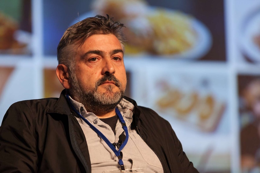 Restaurant owner Frank Camorra on stage at a meeting of chefs.