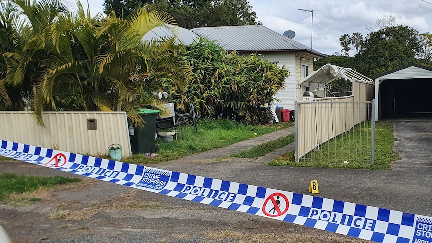 police tape in front of two houses 