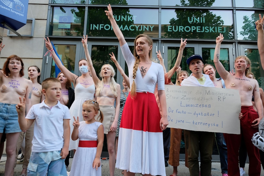 Women stand in protest outside the European Commission office in Poland