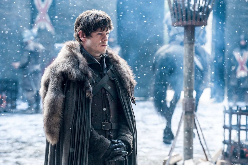 Ramsay Bolton in season six of Game of Thrones stands in the snow.