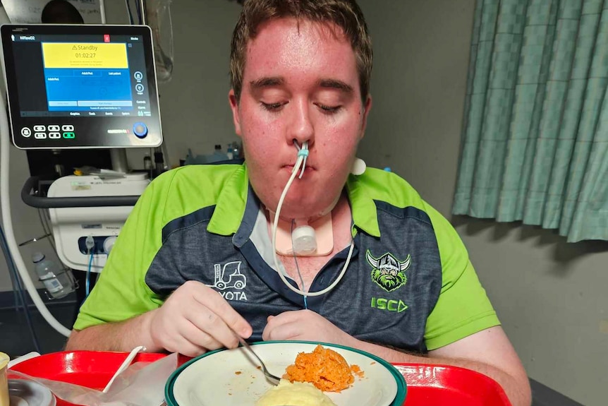 A man eats a meal in hospital