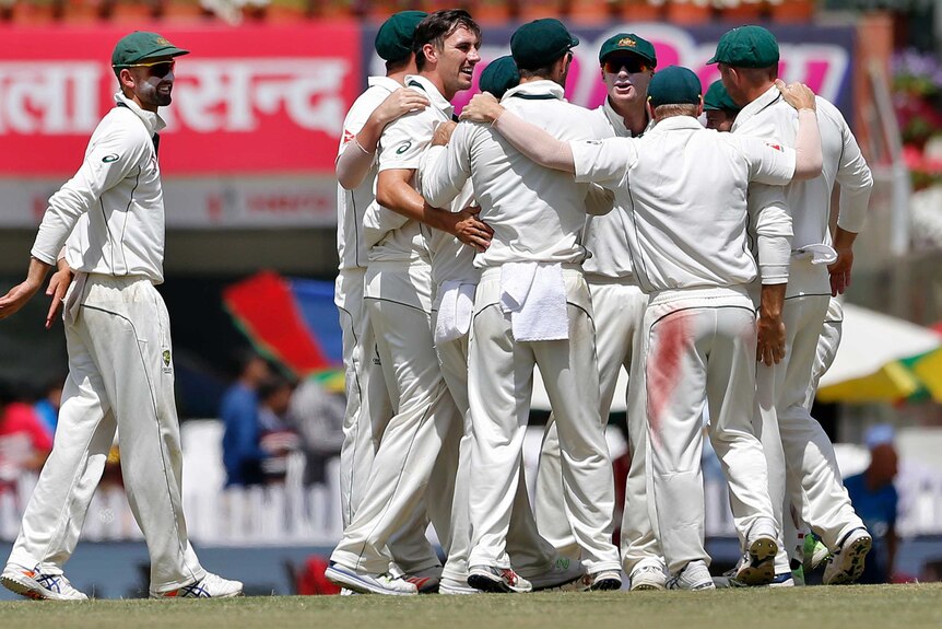 Pat Cummins and Australia celebrate the wicket of Virat Kohli