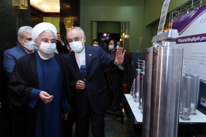 Iranian President Rouhani looks over Iran's nuclear achievements in Tehran.