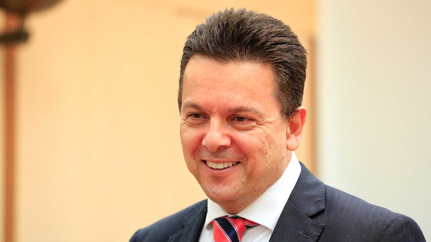 South Australian Senator Nick Xenophon smiles as he speaks to reporters in Canberra