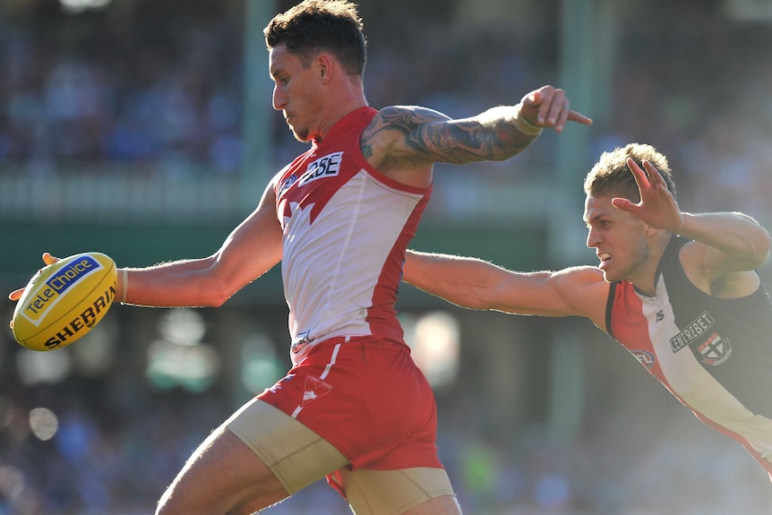 Jesse White kicks clear for the Swans