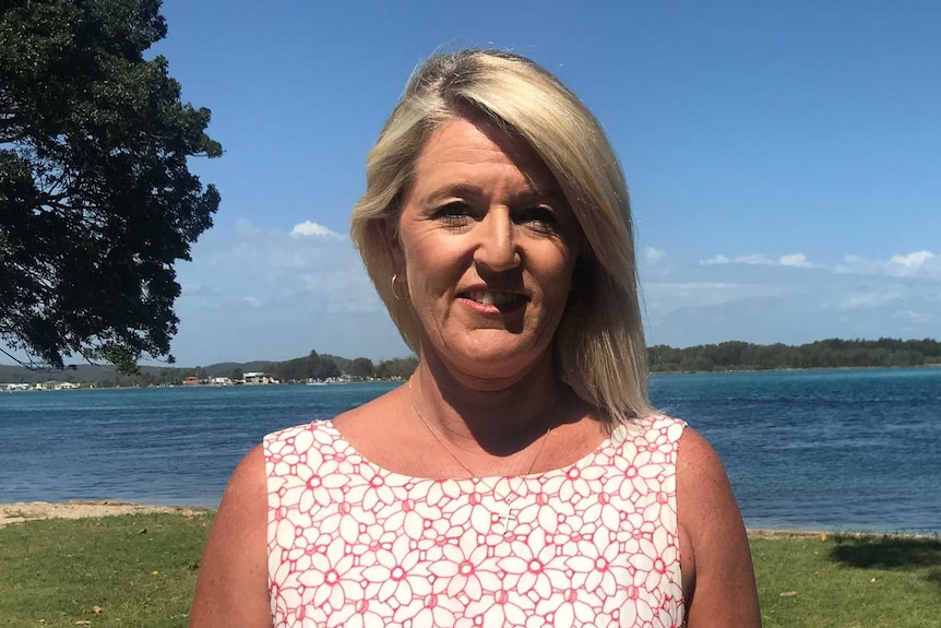 Blonde haired woman in front of lake macquarie