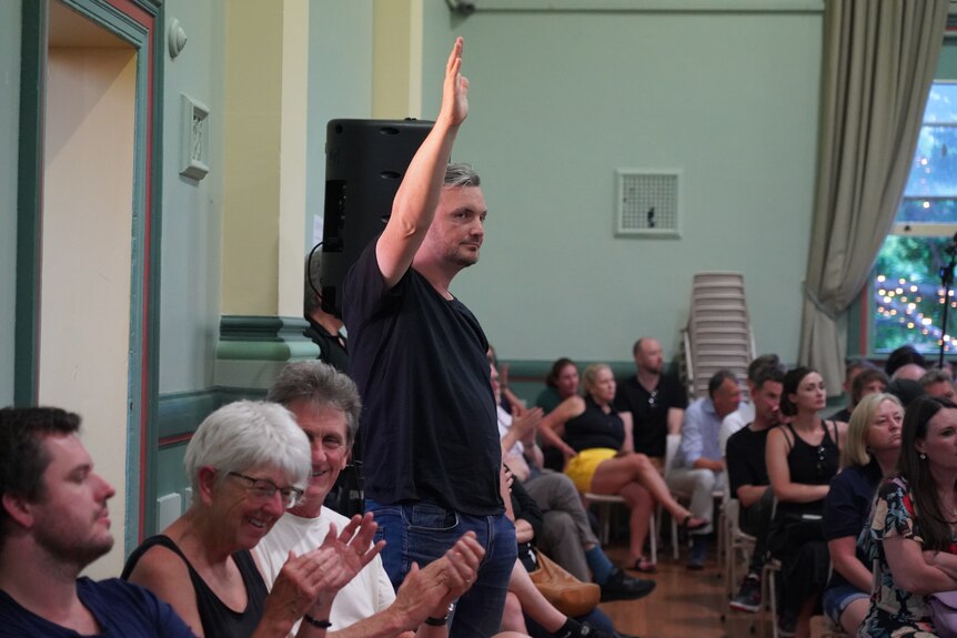 Nathan English, former active transport planner, raises his hand at public meeting about Rozelle Interchange congestion