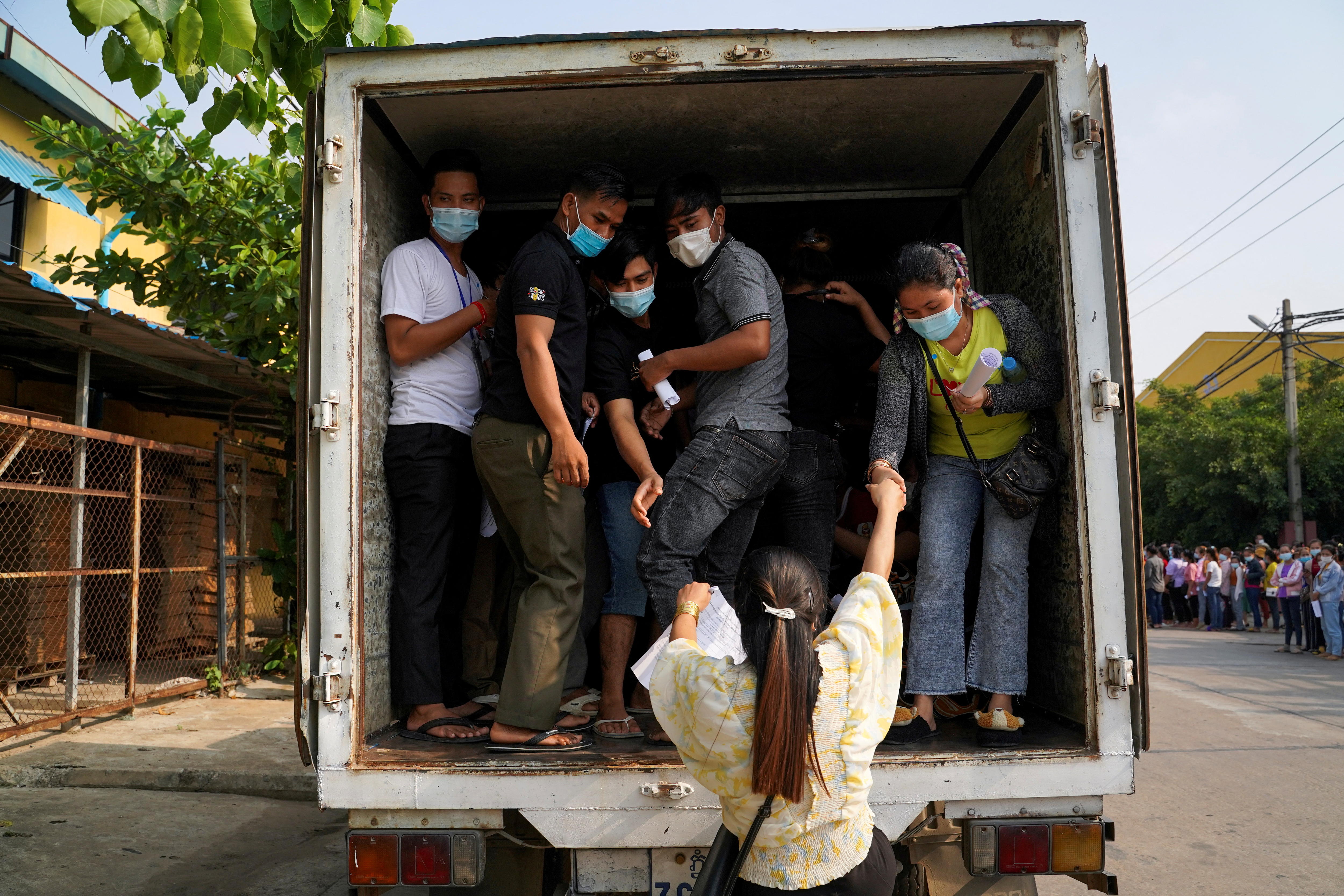 Cambodia garment workers in the back of a truck