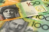 $100 Australian dollar notes layered over each other.