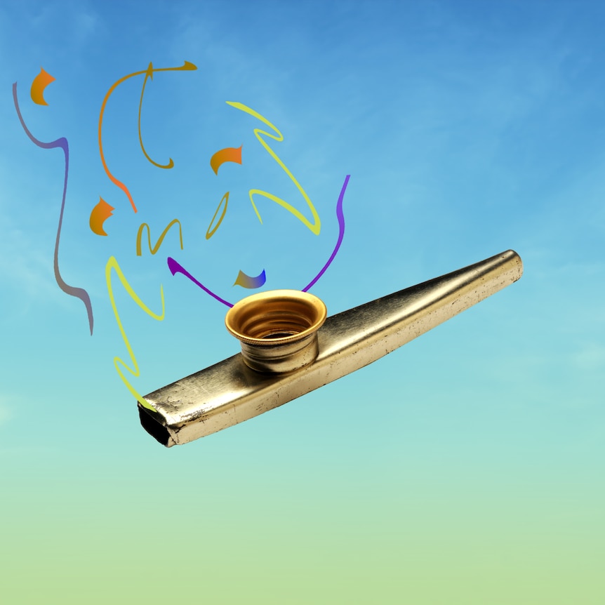 A gold kazoo floating in a blue sky.