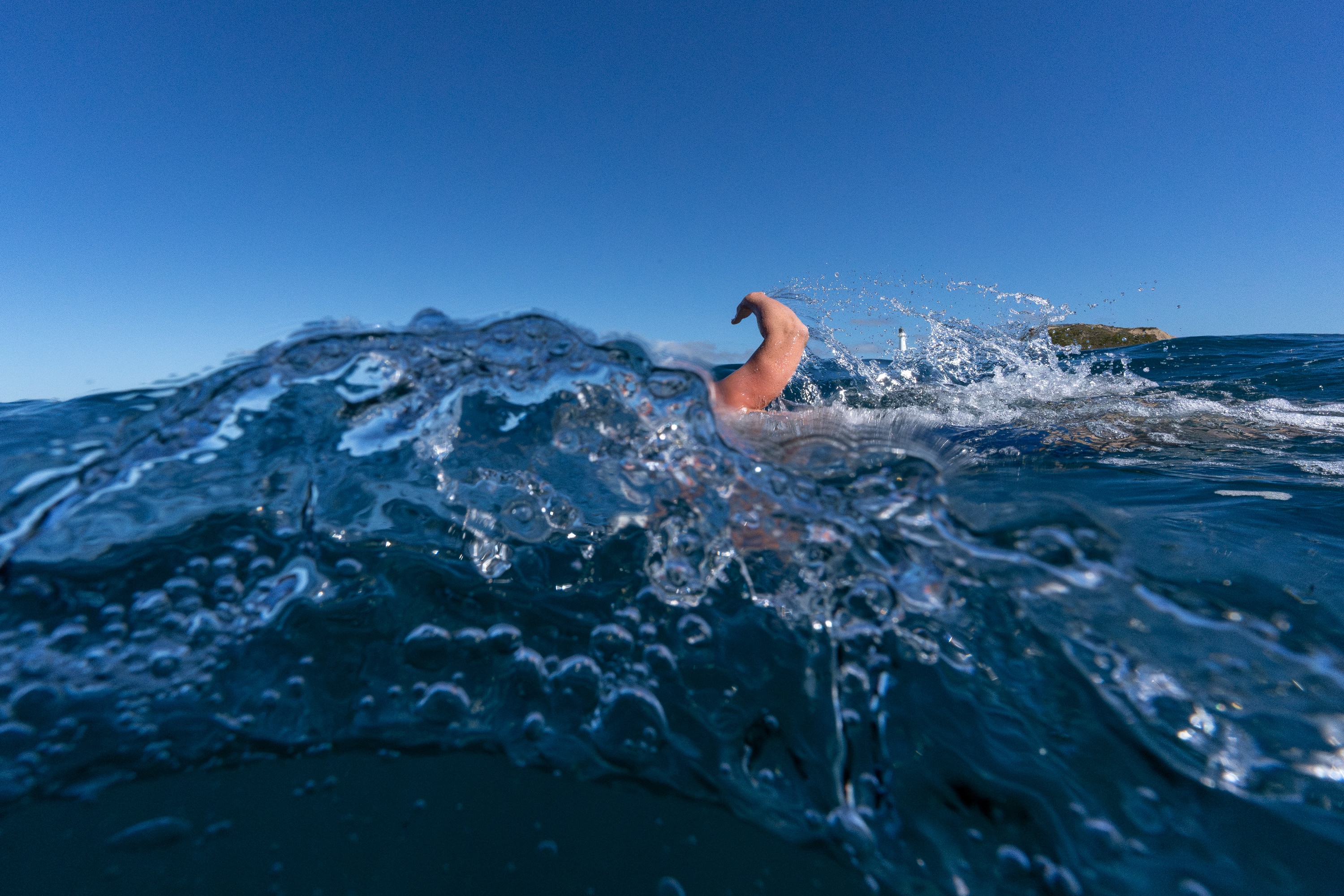 Jono Ridler swims in a wave