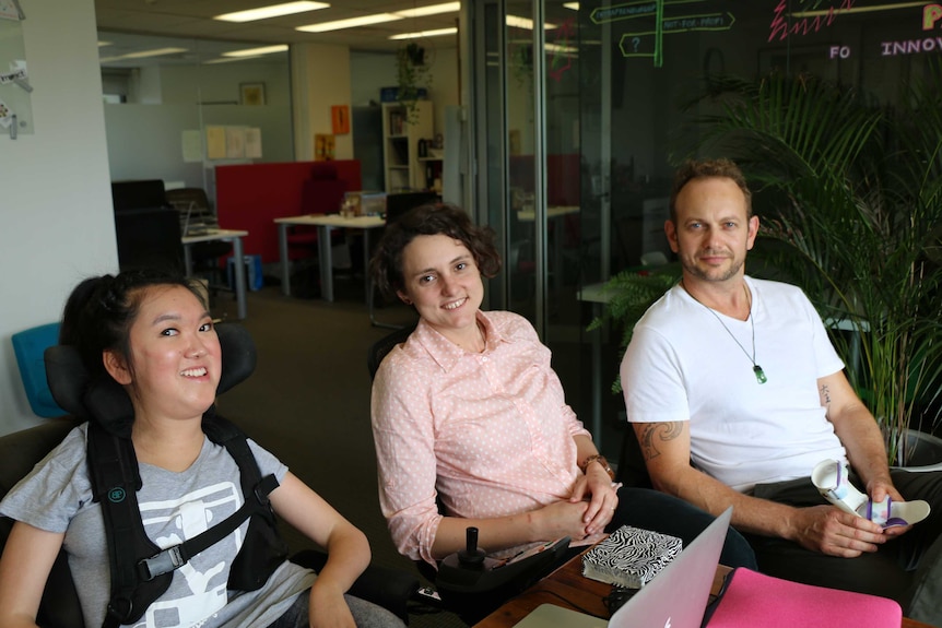 The AbilityMate team sits around their desk