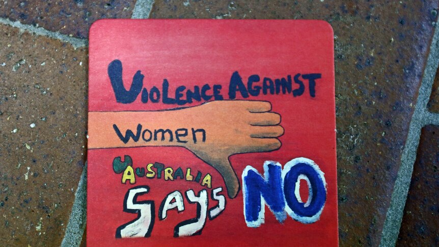 'Violence against women, Australia says no' painted on a coaster.