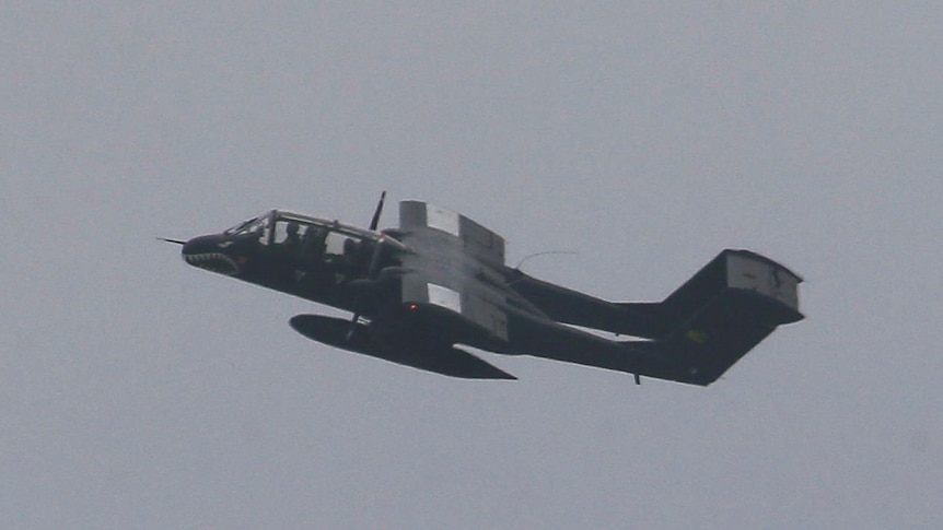 A bomber flies on an upward trajectory.