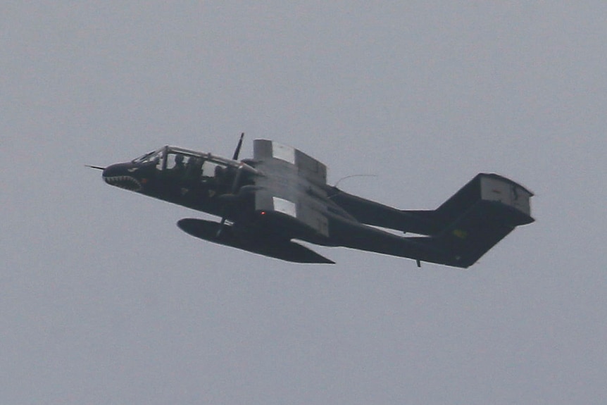 A bomber flies on an upward trajectory.