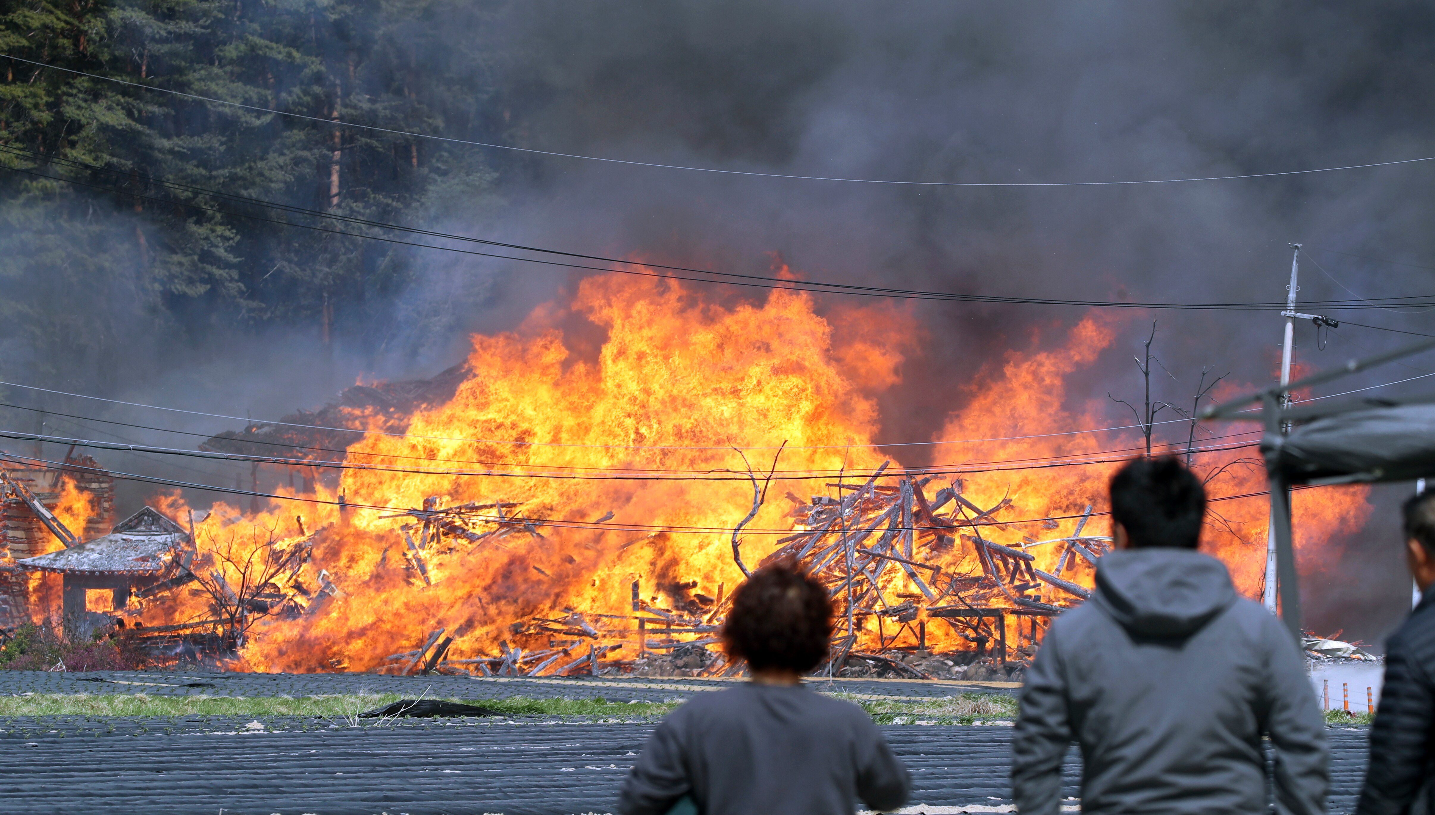Local residents stand near the scene of a fire in South Korea.