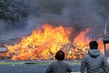 Local residents stand near the scene of a fire in South Korea.