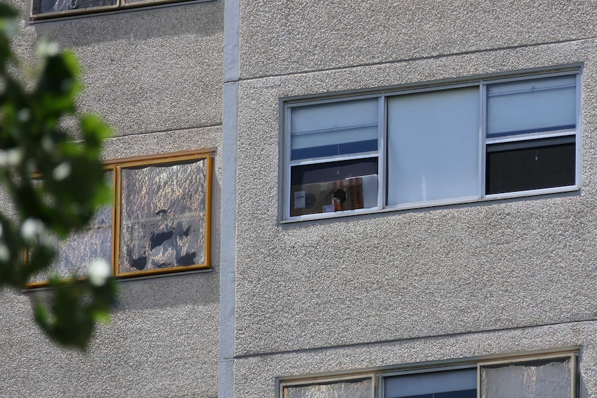 A close-up of a window in a public housing tower block on a sunny day in Prahran.