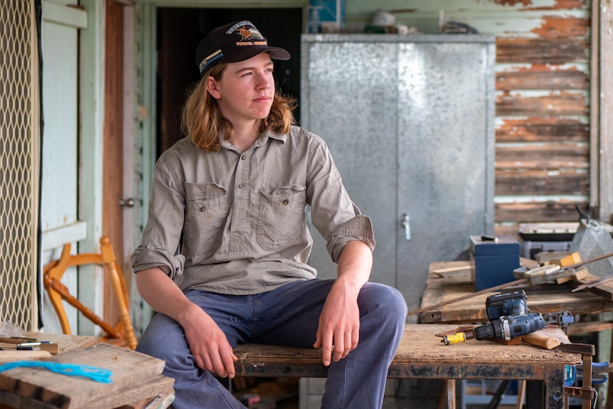 Dom sitting on a table on his veranda, near Longreach, November 2022.