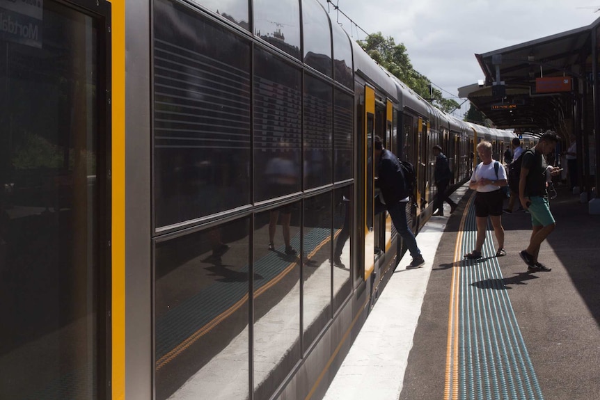 People board a train in Sydney