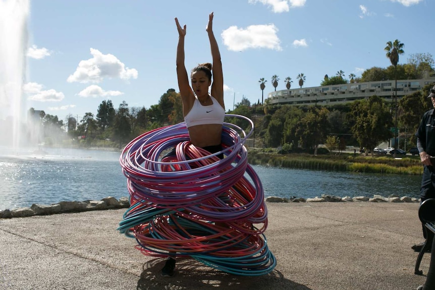Australian performer Marawa Wamp spinning with 200 hula hoops.