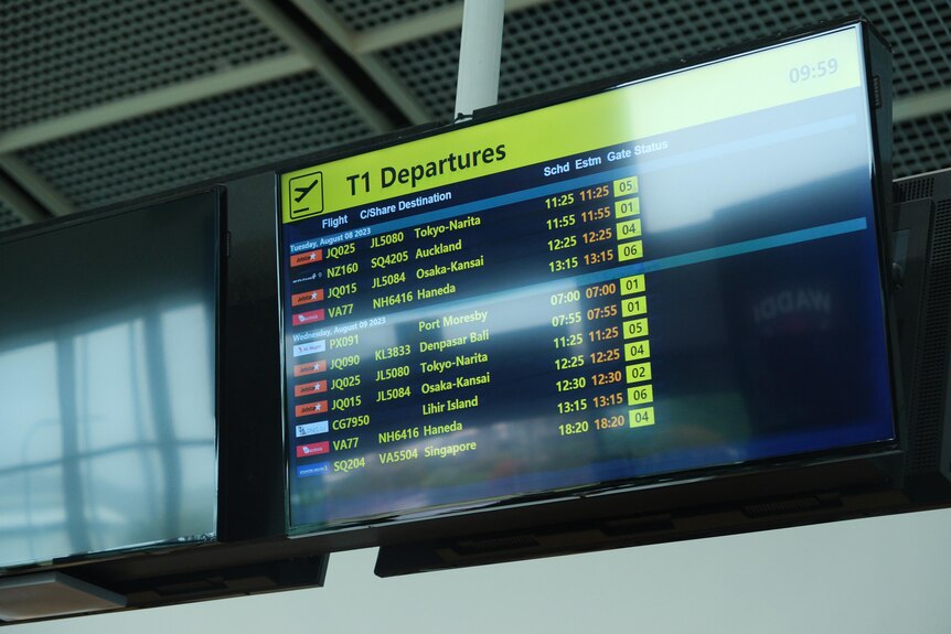 A screen displaying flight departures at an airport.