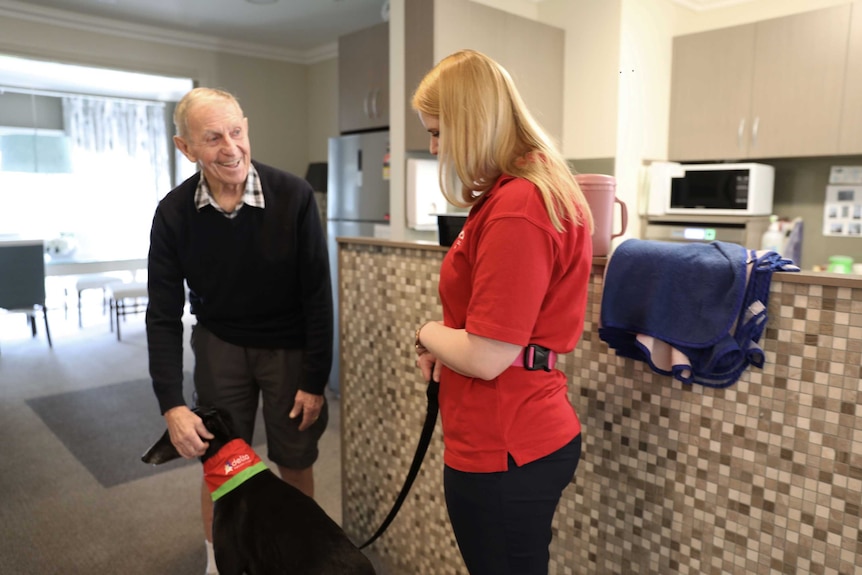 Alana Wade and her dog Tiffany with a resident at Jindalee nursing home.