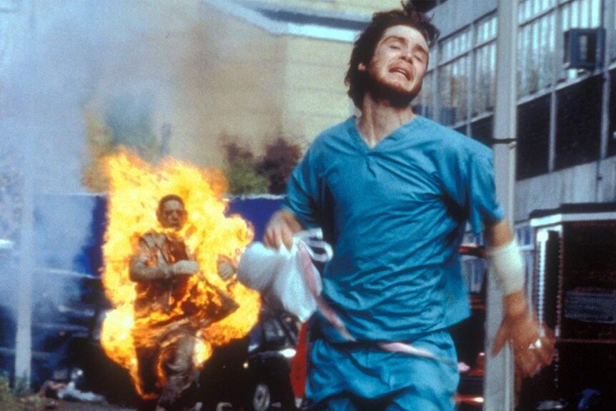 28 Days Later film still showing zombie chasing a man.