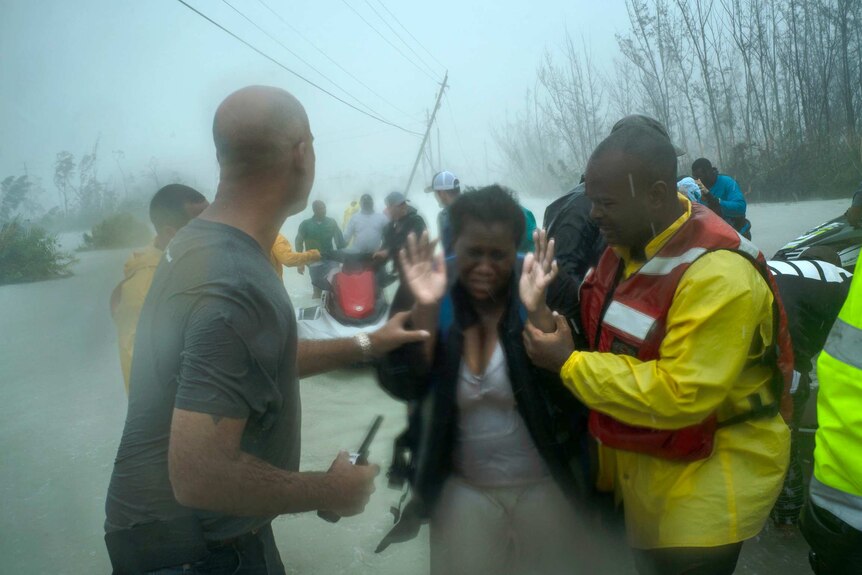 Volunteers rescue several families that arrived on small boats, from the rising waters of Hurricane Dorian in Grand Bahama.