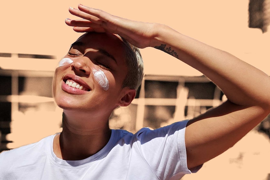 Soumia shields her eyes, smiling looking up at the sun for a story about being sun smart with darker skin