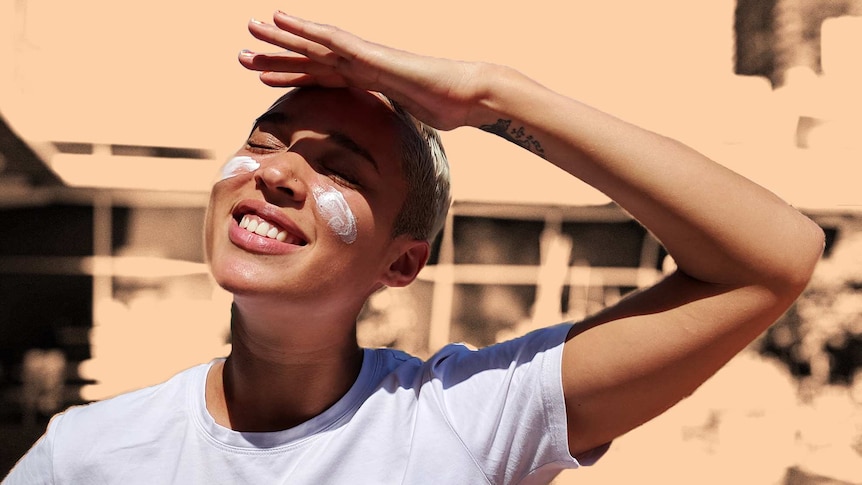 Soumia shields her eyes, smiling looking up at the sun for a story about being sun smart with darker skin