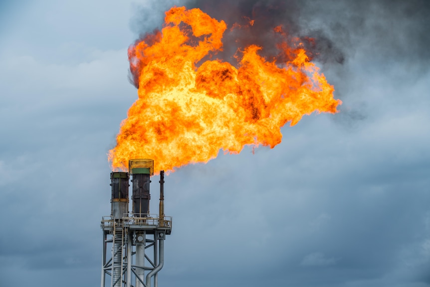 A savage-looking flame bellows into the sky from a stack.