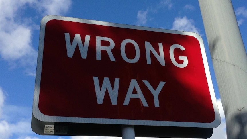 A wrong way sign on the road