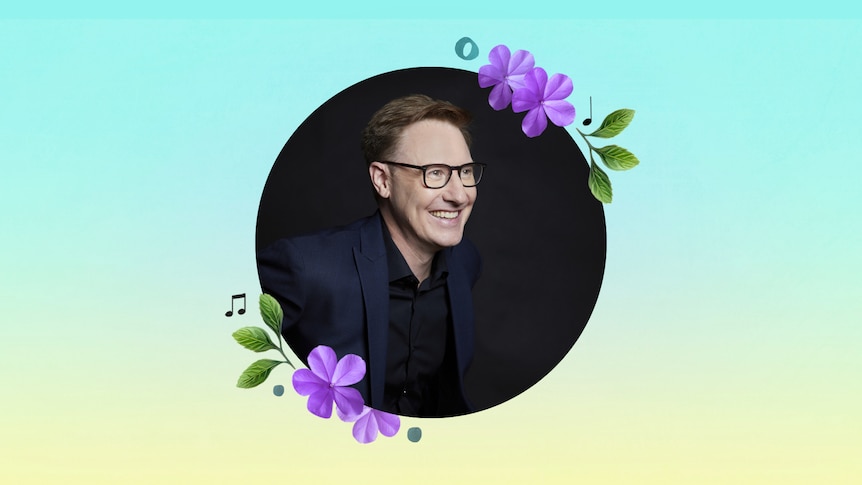 Benjamin Northey wearing glasses sits smiling facing to the left of the pitcure, in a cut out circle surrounded by flower motifs