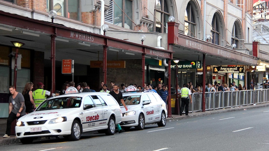 People queue for taxis in Brisbane's Fortitude Valley.